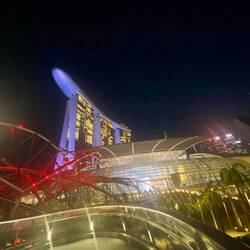 Red light double helix bridge in foreground. Rude purple thing is SkyPark on 56th floor.