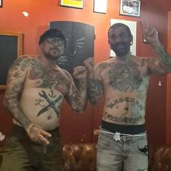 A photo shoot to promote the guy on the right's tattoo shop.