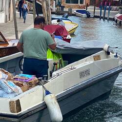 Mail delivery by boat, before a mailman walks the letters to the various businesses and houses.