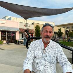 James listening to music waiting for me to finish shopping that the farmers market