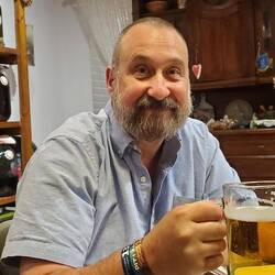 Cheers, notice the wall of homemade liquor in the background.