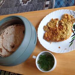 Breakfast, chapati with scambled eggs eith onion, mint tea