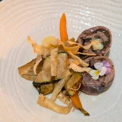 Tuna rolled around spinach and leek (I think) and grilled lightly. Served with vegetables