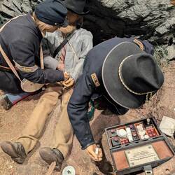 Caring and helping a wounded Confederate