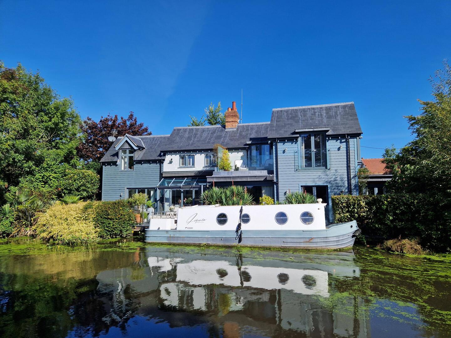 A very attractive looking canalside house with matching boat