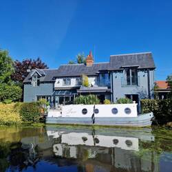 A very attractive looking canalside house with matching boat