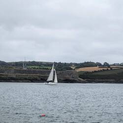 Sailboat heading out of the harbour.