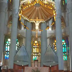 Jesus on the cross. Grape vines and wheat around the parasol, depicting the Eucherist.