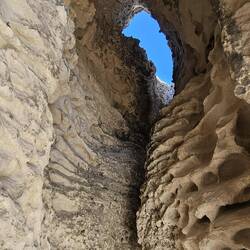 Half way down the beach, we found this cool old blow hole.