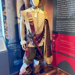 In a museum. This looks like the Musketeers costume
