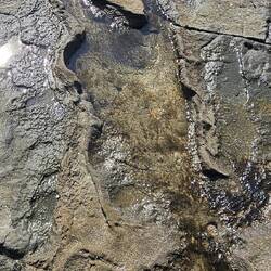 Look closely. A volcanic stone hits this lava area on a angle to create this effect. I love it