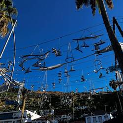 Spdriftwood sailboats hanging by the port in Cámara da Lobos.