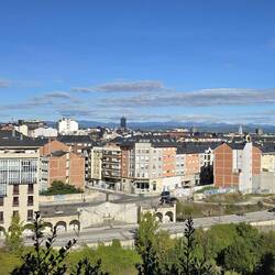 Views from the fortress over the new town, with the surrounding mountains in the background