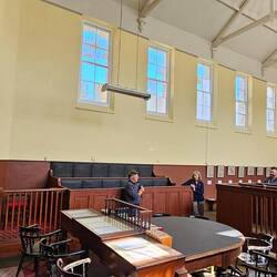 Listening to our guide in one of the courtrooms.