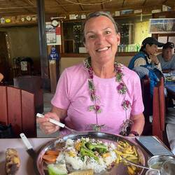 You mix all the parts together: rice, pickled veg, sauce, greens