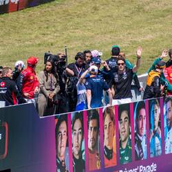 Driver parade around the track on the back of a truck