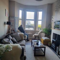 A really cozy sitting room with an electric fireplace.