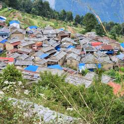 Tikot. Houses have slate rooves. The village is connected by rock pathways everywhere
