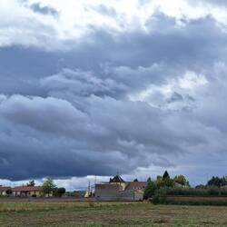 The clouds are so heavy, they look like they are going to touch the ground.