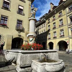 Another wooden statue and fountain