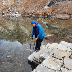 Dipping his poles and foot