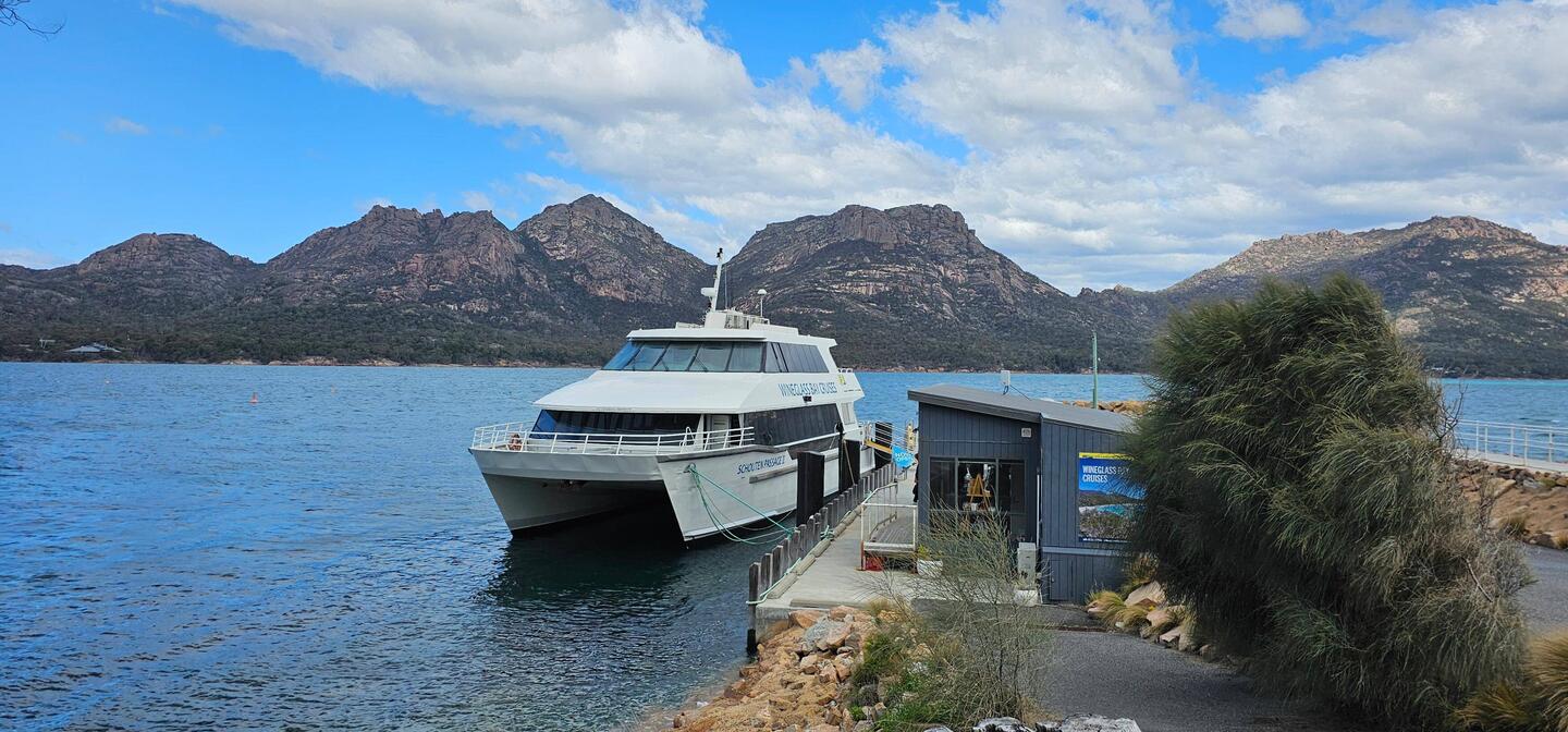 The cruise/tour boat with granite mountains backdrop