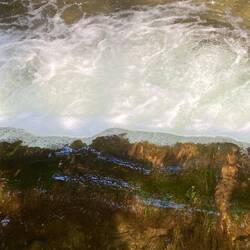 Water flowing over the edge like a thick sheet of glass