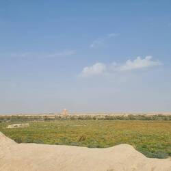 The outer wall of the city in the distance