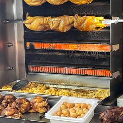 Roast chooks with potatoes roasting below in the juices of the chicken and some duck fat