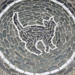 On the side walk in front of the house