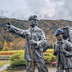 A Tlingit guide leads a prospector out of town and up into the mountains in search of gold.