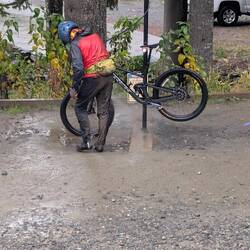After spraying off his bike, he spayed himself off