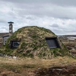 Ancient Sami Hut built of logs, peat, bark, and other natural building materials.