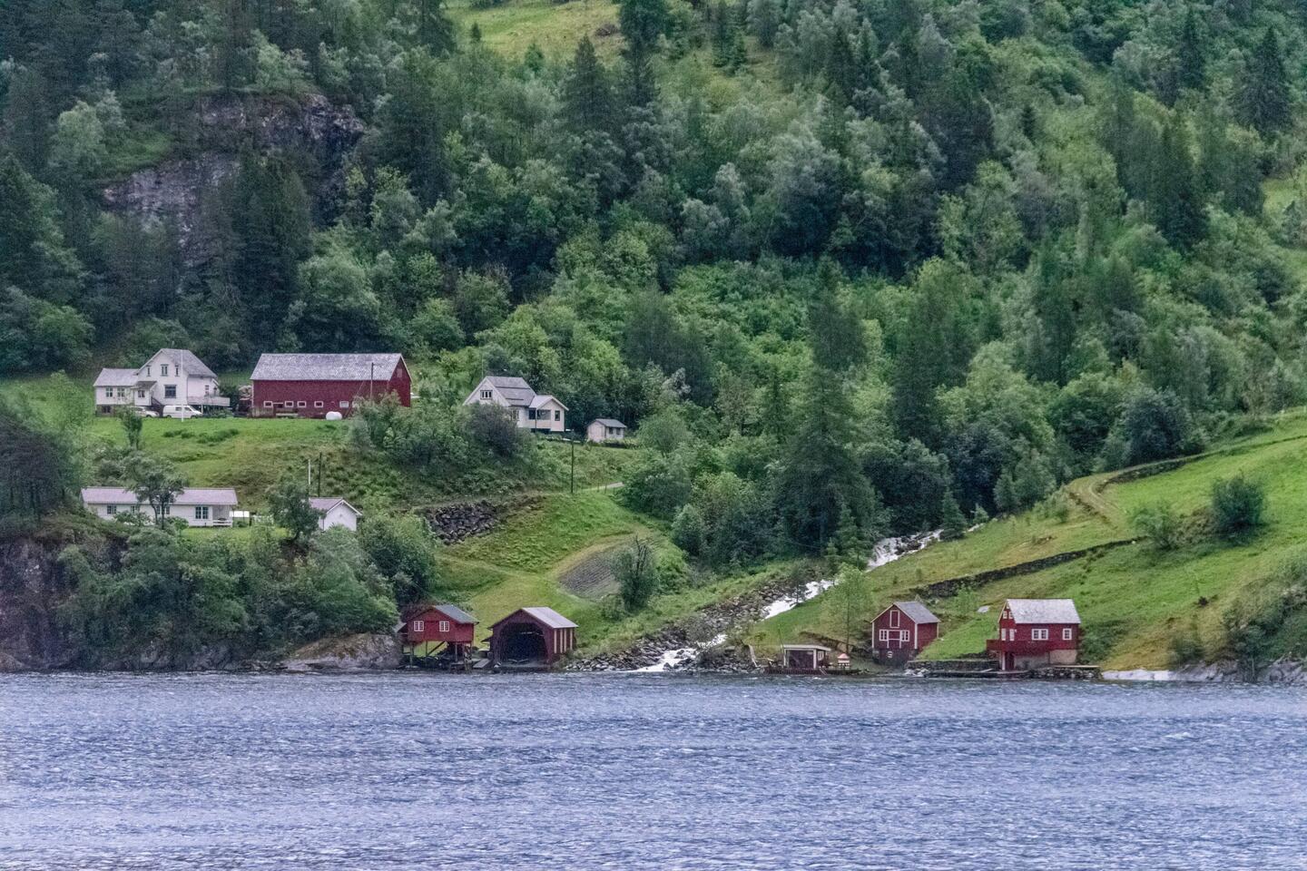 Norwegian farm building on side of fjord