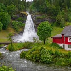 Steinsdalsfossen is a 46m waterfall with an easy trail allowing you to go behind it.