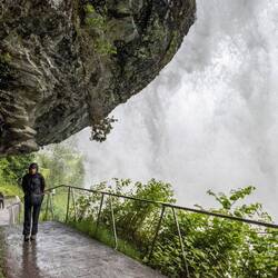 Walking under Steinsdalsfossen waterfall.