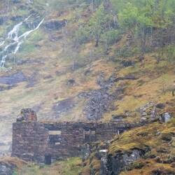 Actress, dressed as a legendary Huldra, dances and sings in front of the waterfall.