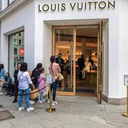 Queue to enter Louis Vuitton store.