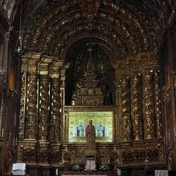 Silver tomb of Queen Isabel is lit up behind the central figure