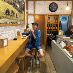 Debbie hooking into pork sandwich for brekky