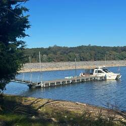 MB at the dock at Crooked Creek Bay. Energy Lake dam in background