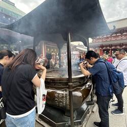 Sand filled urn with smoke carrying prayers up to the Gods.