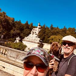 In front of giant koi pond in le Jardin de la Fontaine