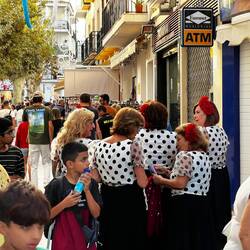 A group of ladies wearing traditional Andalusian dresses for the feria.