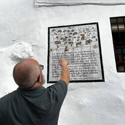 Sergio points to one of the many history panels lining Frigiliana's narrow alleys.