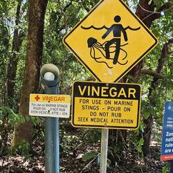 Stinger (jellyfish) warning signs. They even provide vinegar if you get stung!