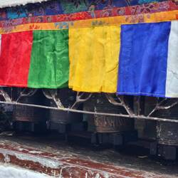 Prayer wheels surround the stupa