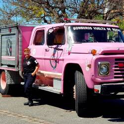 Old firefighters' truck. Two people are dancing tango in the background...