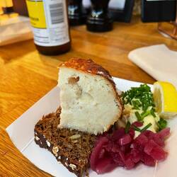 Cod fish ball (1/4) on rye with pickled onion, mayonnaise with pickled vegetables and lemon