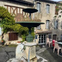 Half wood house with fountain